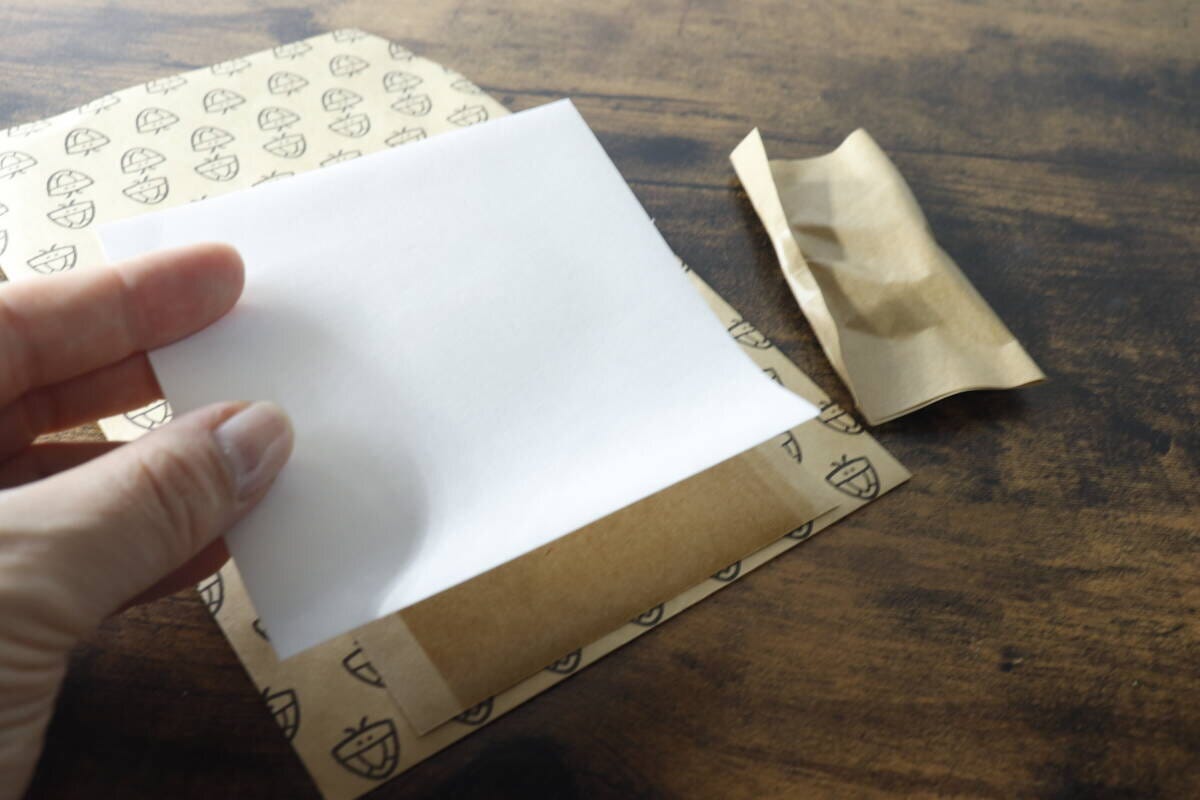 カメムシキャッチャーの粘着シートを保管するため、剥がした白い剥離紙を再度貼り付けている様子 カメムシキャッチャーの粘着シートを保管するため、剥がした白い剥離紙を再度貼り付けている様子