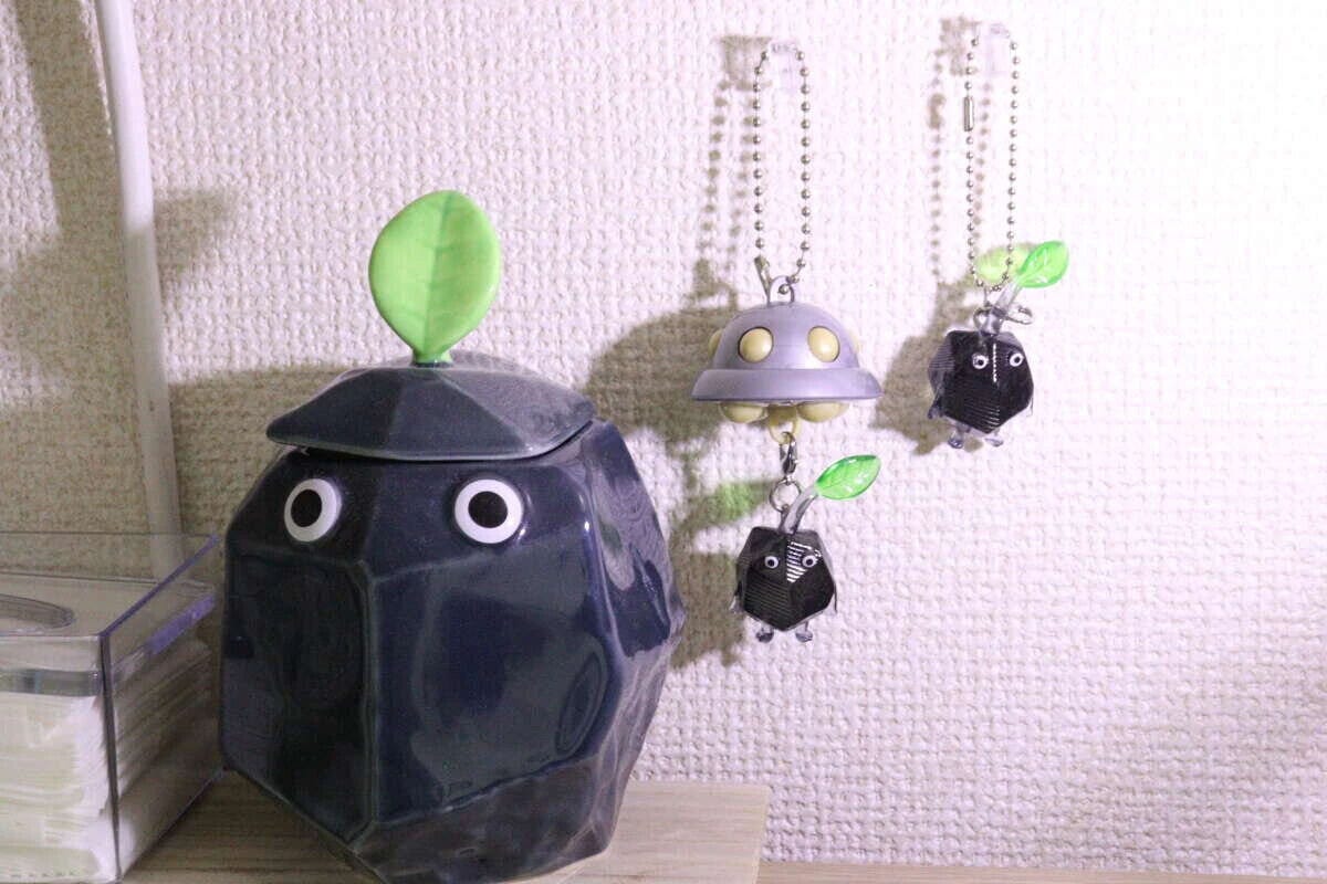 壁に掛けられたピクミンのキーホルダーと岩ピクミン風の置物 壁に掛けられたピクミンのキーホルダーと岩ピクミン風の置物