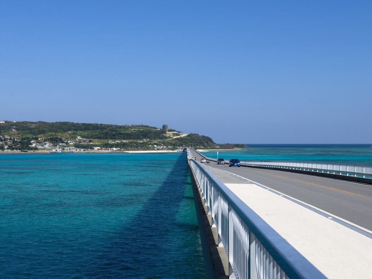 エメラルドブルーの海の上にかかる古宇利大橋を渡って恋の島へ (C)OCVB