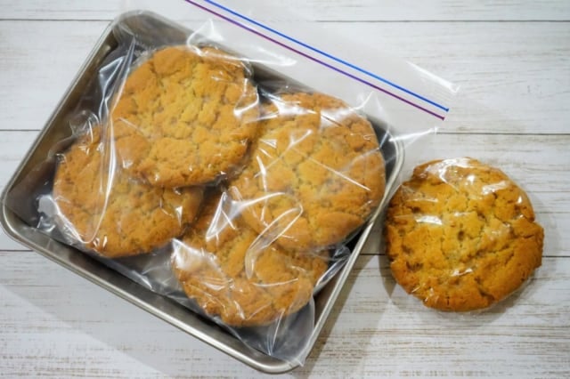 ラップで包んだバラエティークッキーをジップロックに入れて銀のトレーに置いたもの