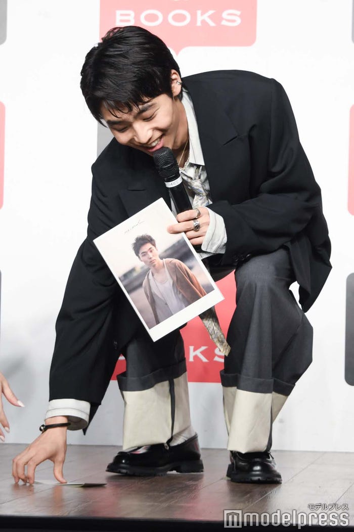 帯を拾う八村倫太郎(C)モデルプレス