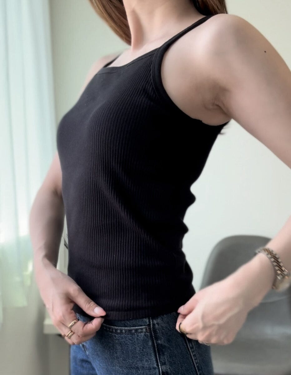 黒いスクエアネックブラキャミソールを着た女性が横向きでウエスト部分に手を添えている 黒いスクエアネックブラキャミソールを着た女性が横向きでウエスト部分に手を添えている