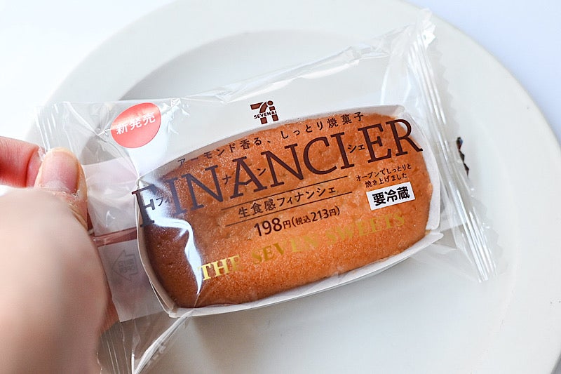 セブンイレブンの生食感フィナンシェのパッケージを持っているところ