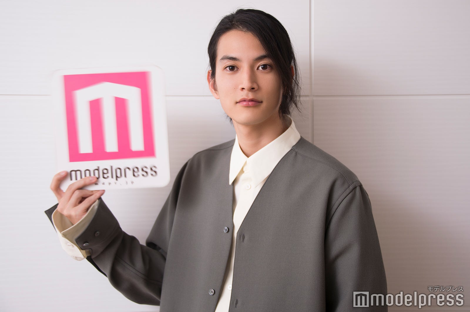 ロゴボードを高速で動かしてカメラマンを翻ろうする渡邊圭祐 （C）モデルプレス