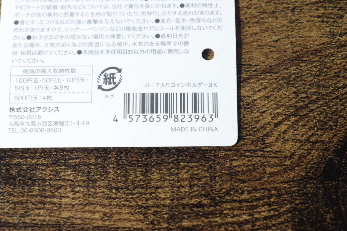 ポーチ入りコインホルダーの商品タグ裏面、バーコードと商品情報が記載されている ポーチ入りコインホルダーの商品タグ裏面、バーコードと商品情報が記載されている