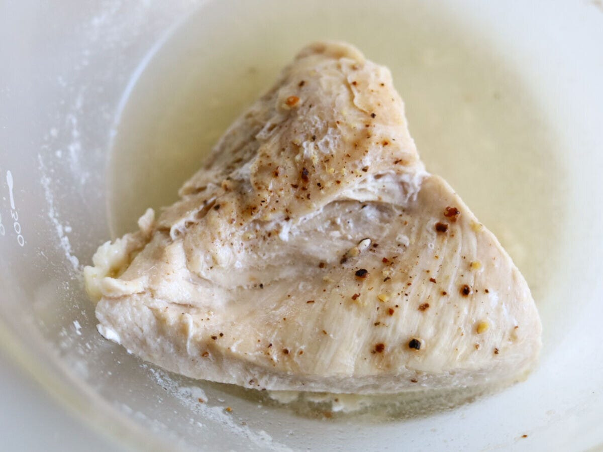 レンジで加熱され白くなった鶏むね肉が、透明なボウルに入っている様子