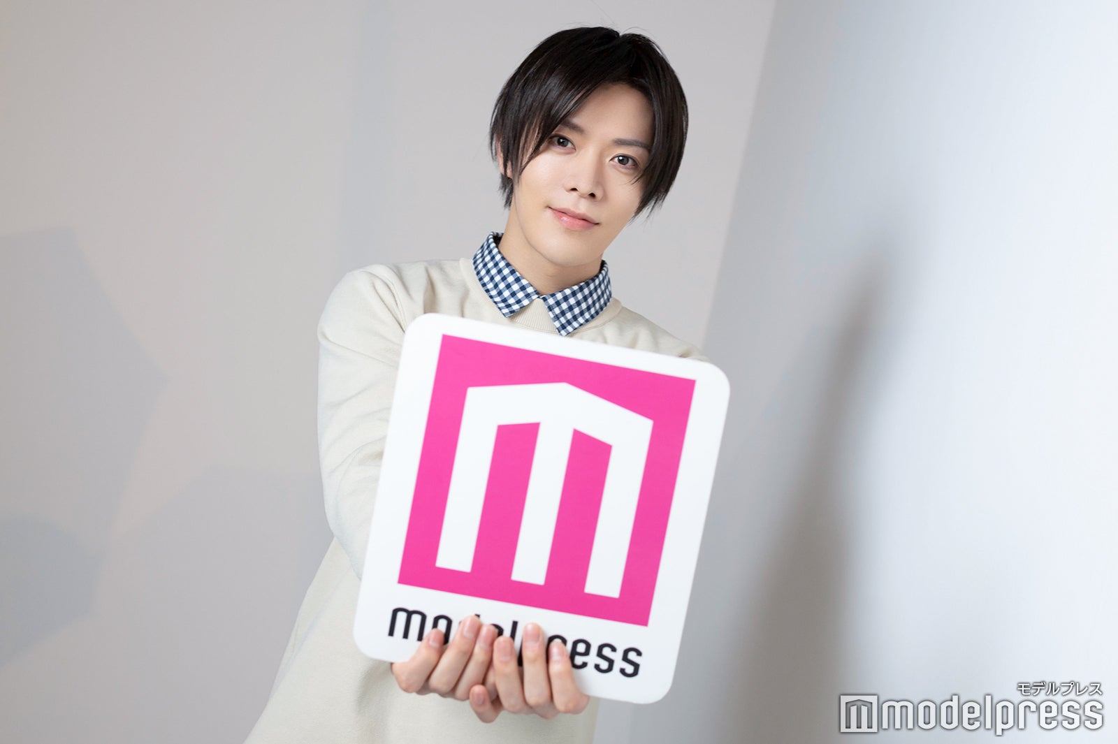 「バレンタインだから」とロゴボードを前に差し出すポーズを決める中本悠太（C）モデルプレス