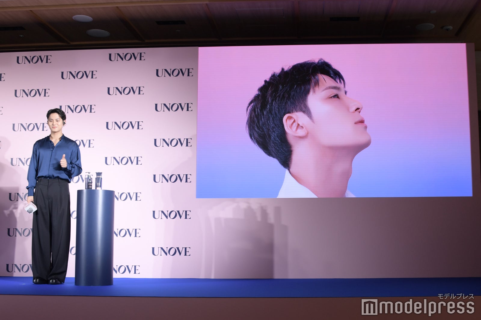 自身の新キャンペーンムービーが流れグッドポーズするミンギュ（C）モデルプレス