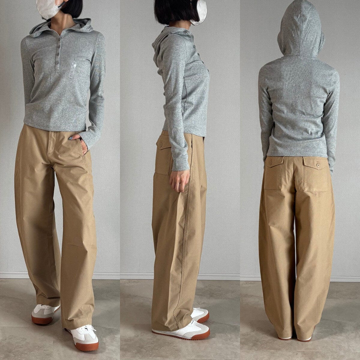 グレーのフーデッドリブTとベージュパンツを着用した女性の全身 グレーのフーデッドリブTとベージュパンツを着用した女性の全身
