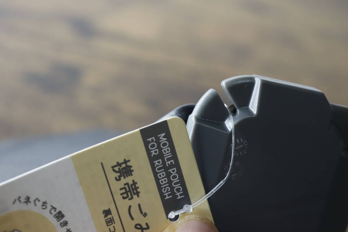 3WAY開封カッターで商品タグの紐を切っている手元 3WAY開封カッターで商品タグの紐を切っている手元