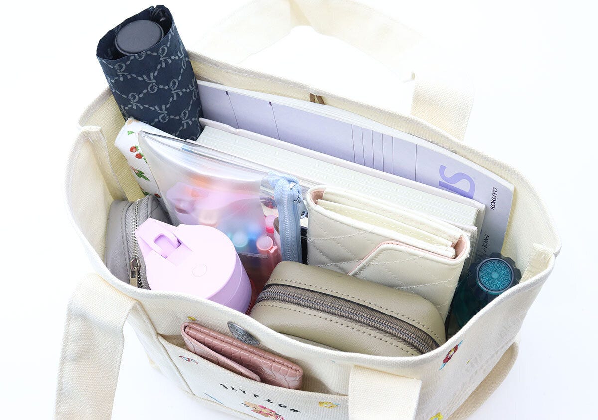 トートバッグの中に折り畳み傘やノートなど荷物がたくさん入っている