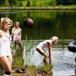 Attacking formation ... girls fool about in a lake for Playboy shoot Sacha Höchstetter for Playboy July 2011/(C)Playboy