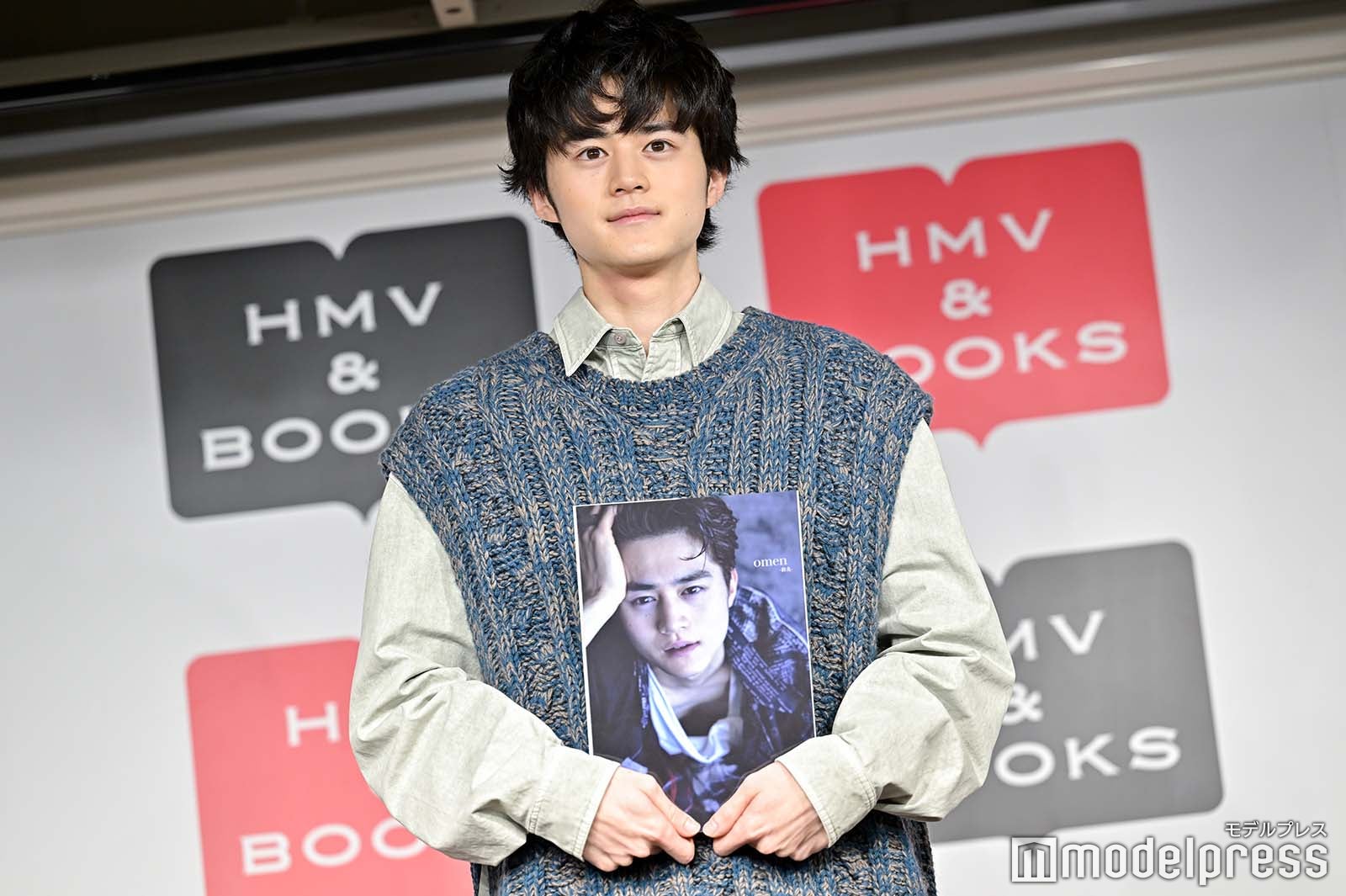 写真集を大切に抱える鈴鹿央士（C）モデルプレス