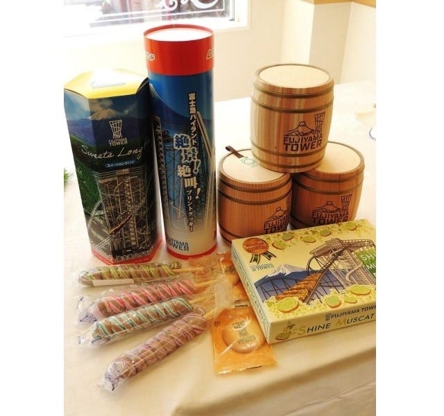 「FUJIYAMA タワー」にちなんだ商品もいろいろ。奥の左から、スイートロングチョコパイ970円、絶景!絶叫プリントクッキー960円、樽入りチョコインクッキー1個1320円。手前の左から、スパイラルキャンディ1個440円、シャインマスカットラスク550円