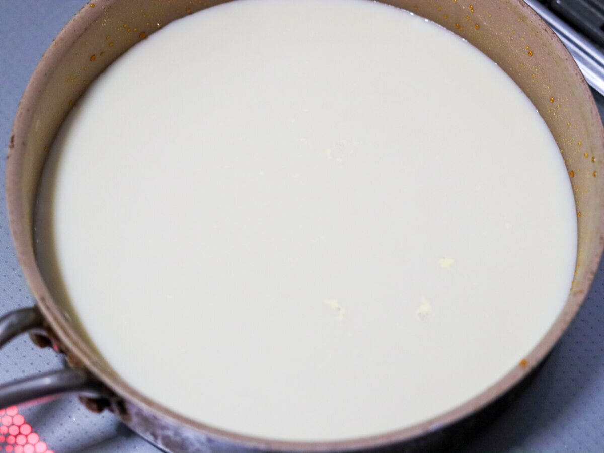 カラメルを作ったあとの小鍋に豆乳を入れて火にかけている様子