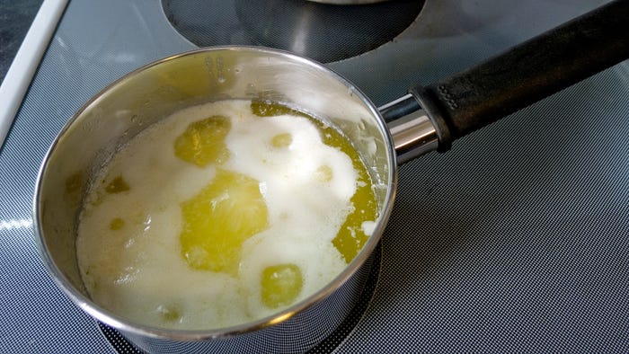 Ghee milk solids cooking off by Larry Jacobsen