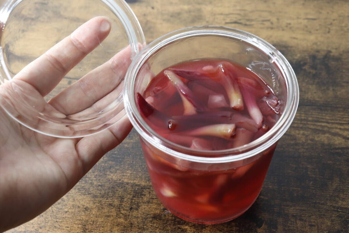 茗荷の甘酢漬けが入った容器の蓋を開けている手元