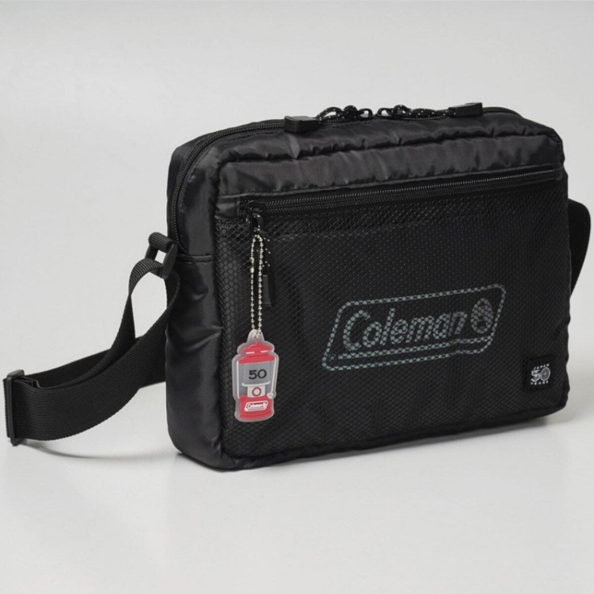 黒いColemanショルダーバッグ。メッシュポケットとランタンチャーム付き 黒いColemanショルダーバッグ。メッシュポケットとランタンチャーム付き