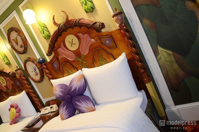 ベッドには花モチーフのクッションなど