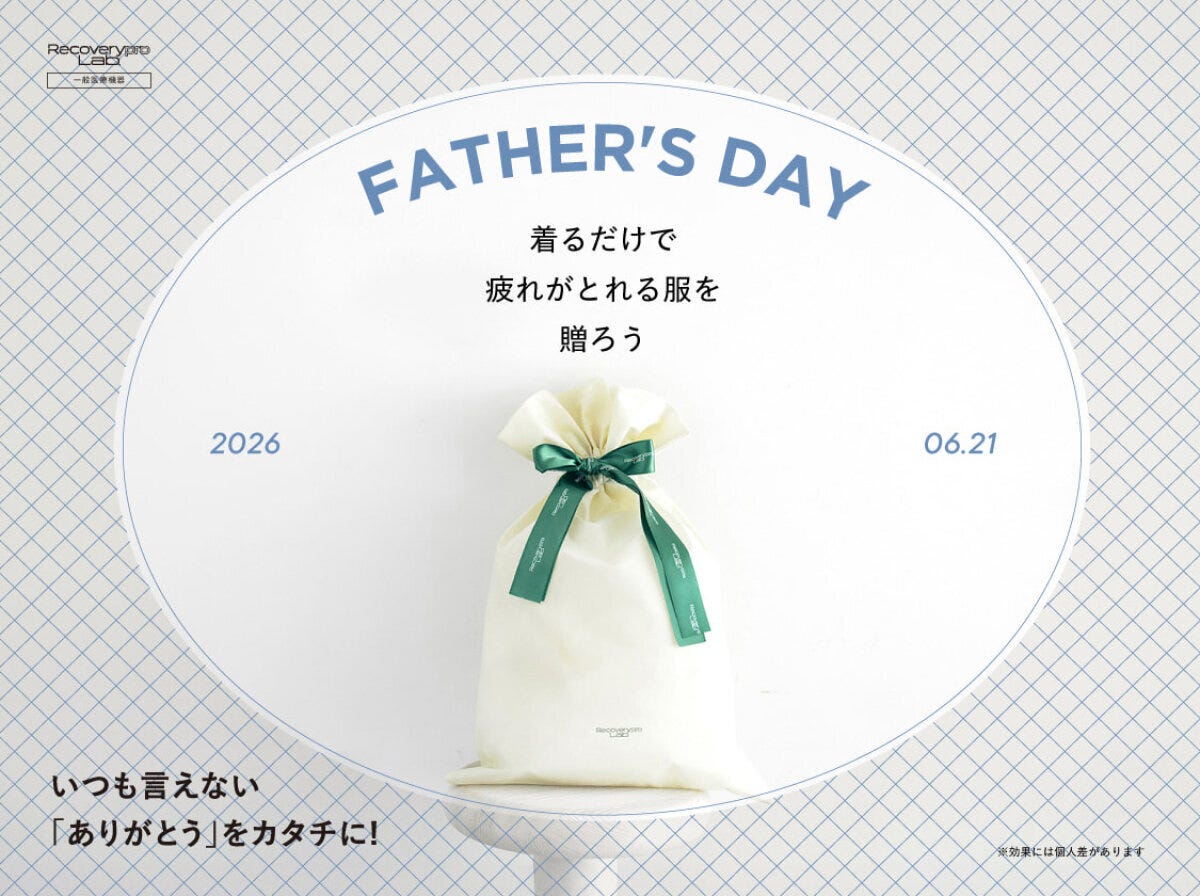 丸椅子の上に置かれた緑色のリボンを結んだ生成り色のギフトバッグと、FATHER’S
