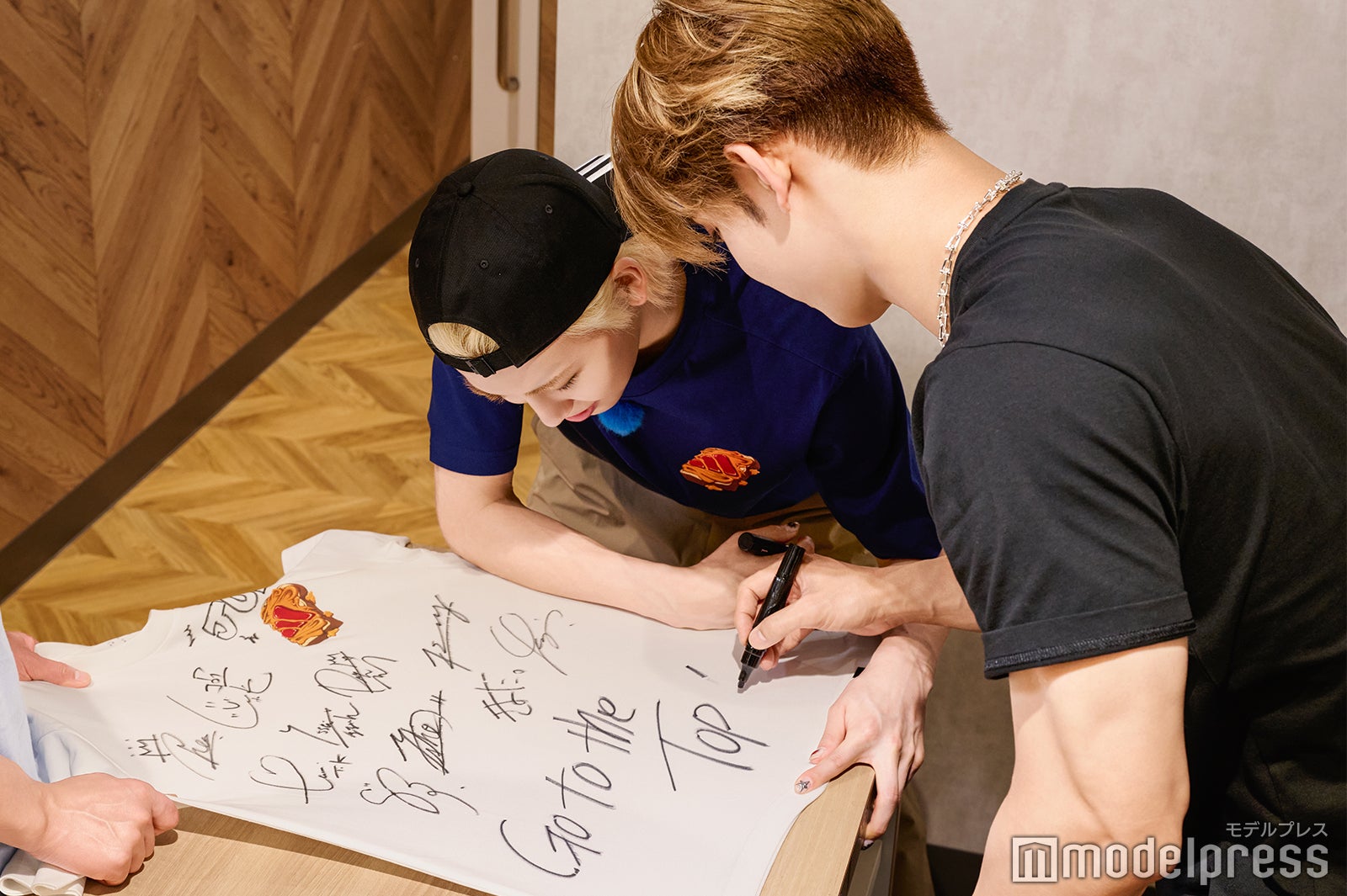 共同作業でサイン入れをする與那城奨と川尻蓮（C）モデルプレス