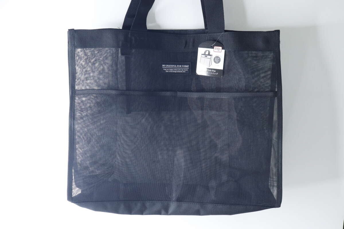 黒いメッシュトートバッグが正面から写っており、商品タグが見える 黒いメッシュトートバッグが正面から写っており、商品タグが見える