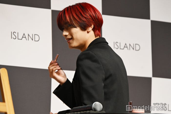 一斉に写真を撮られるのが恥ずかしくて後ろを向いて塗ろうとする高橋恭平(C)モデルプレス