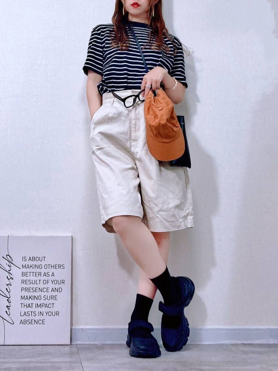 黒白ボーダーTシャツにハーフパンツ、キャップ、伊達メガネを合わせた女性の全身コーデ