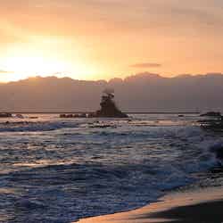 立山連峰から昇る朝日が黄金色に輝き、その中に「女岩」のシルエットが浮かび上がります/提供画像