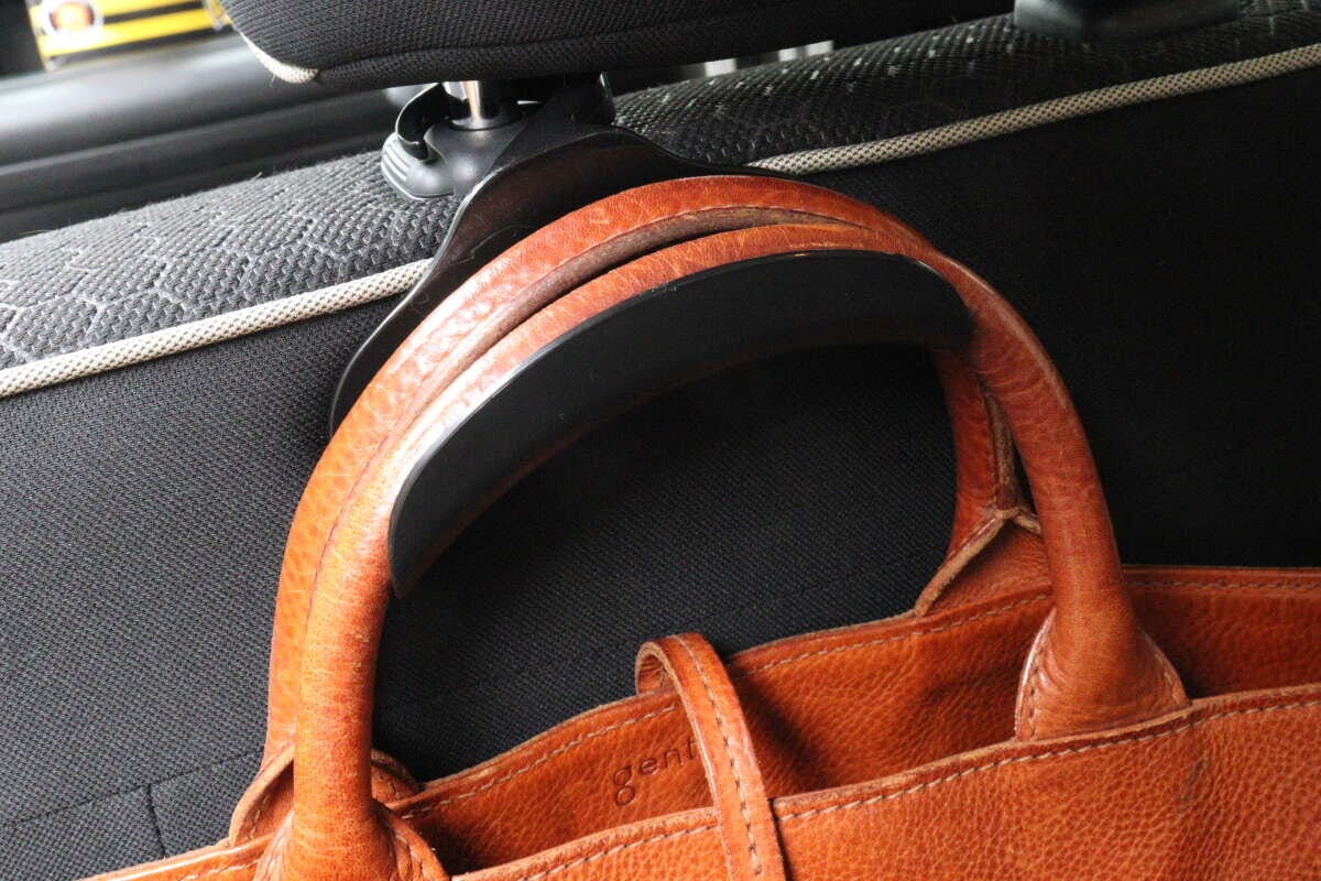 車用バッグフックに茶色い革のバッグが掛けられている様子
