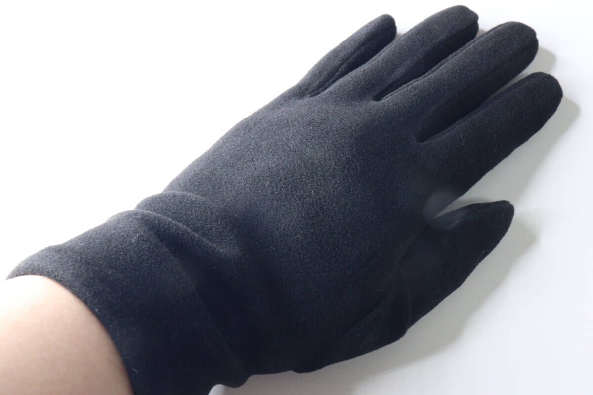 女性が黒い手袋を着用し、手のひらを広げている様子