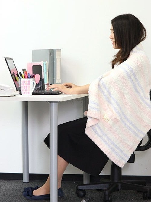オフィスでブランケットをかけた女性