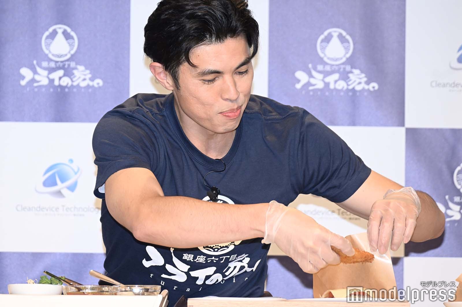 ハンバーガーを手に取ろうとする小島よしお （C）モデルプレス