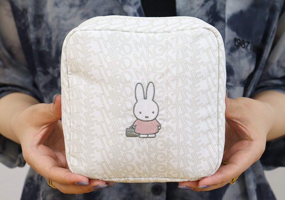 女性がミッフィー刺繍のポーチを両手で持っている